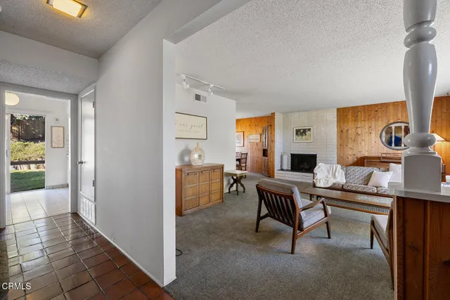 a view of a hallway with a dining area