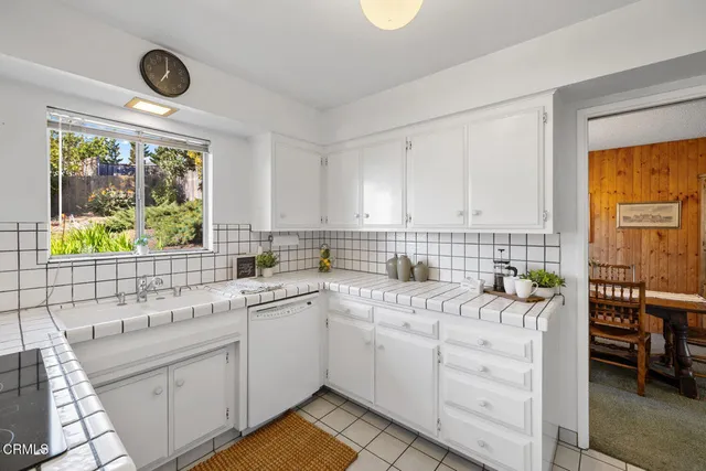 a view of a hallway to rooms and stairs