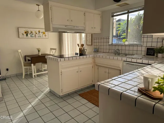a kitchen with a sink cabinets and window