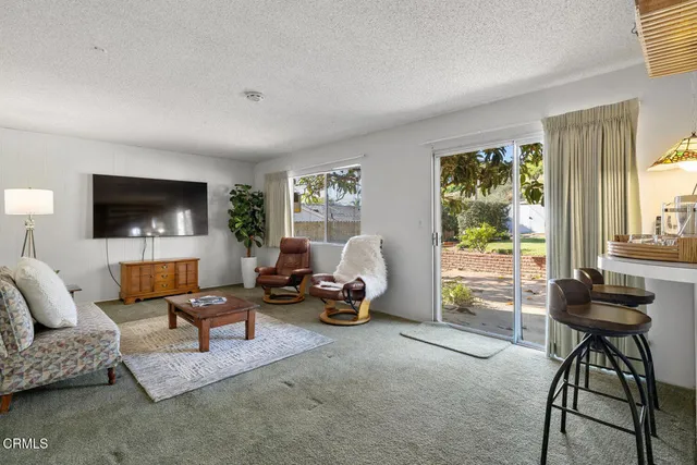 a view of a backyard with plants and outdoor seating