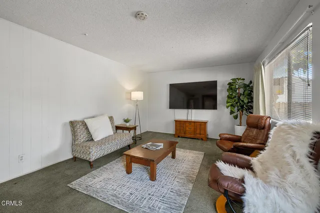 a view of a house with backyard sitting area and garden