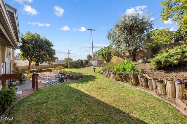 a view of a house with backyard porch and sitting area
