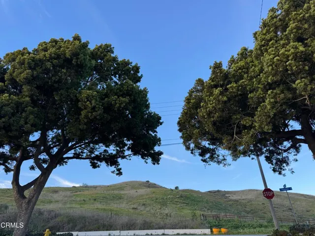 a bedroom with a bed and a large window with the outer view