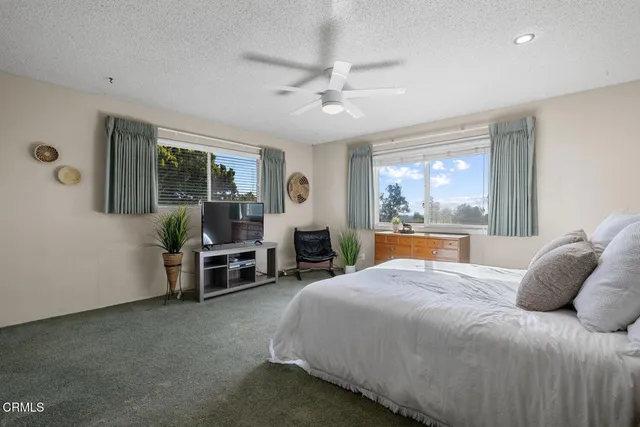 a bathroom with a granite countertop sink mirror vanity and toilet
