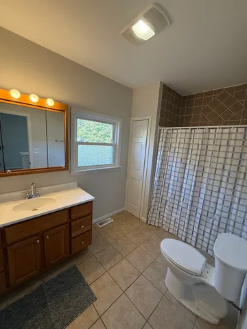 a bathroom with a sink a toilet and mirror