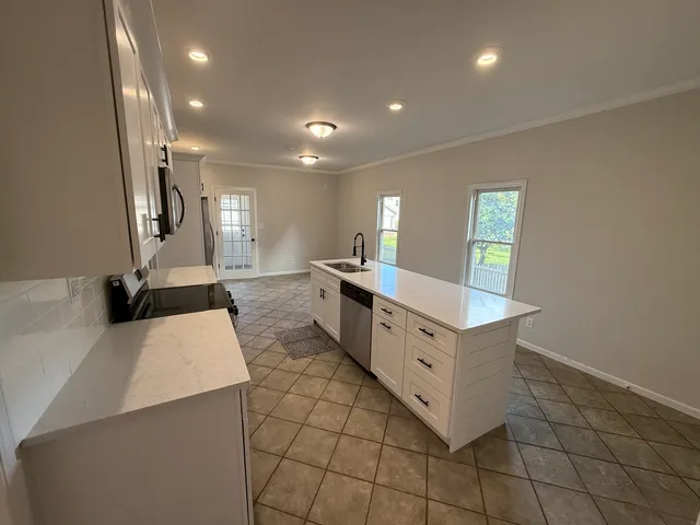 a kitchen with stainless steel appliances a sink and a counter top space
