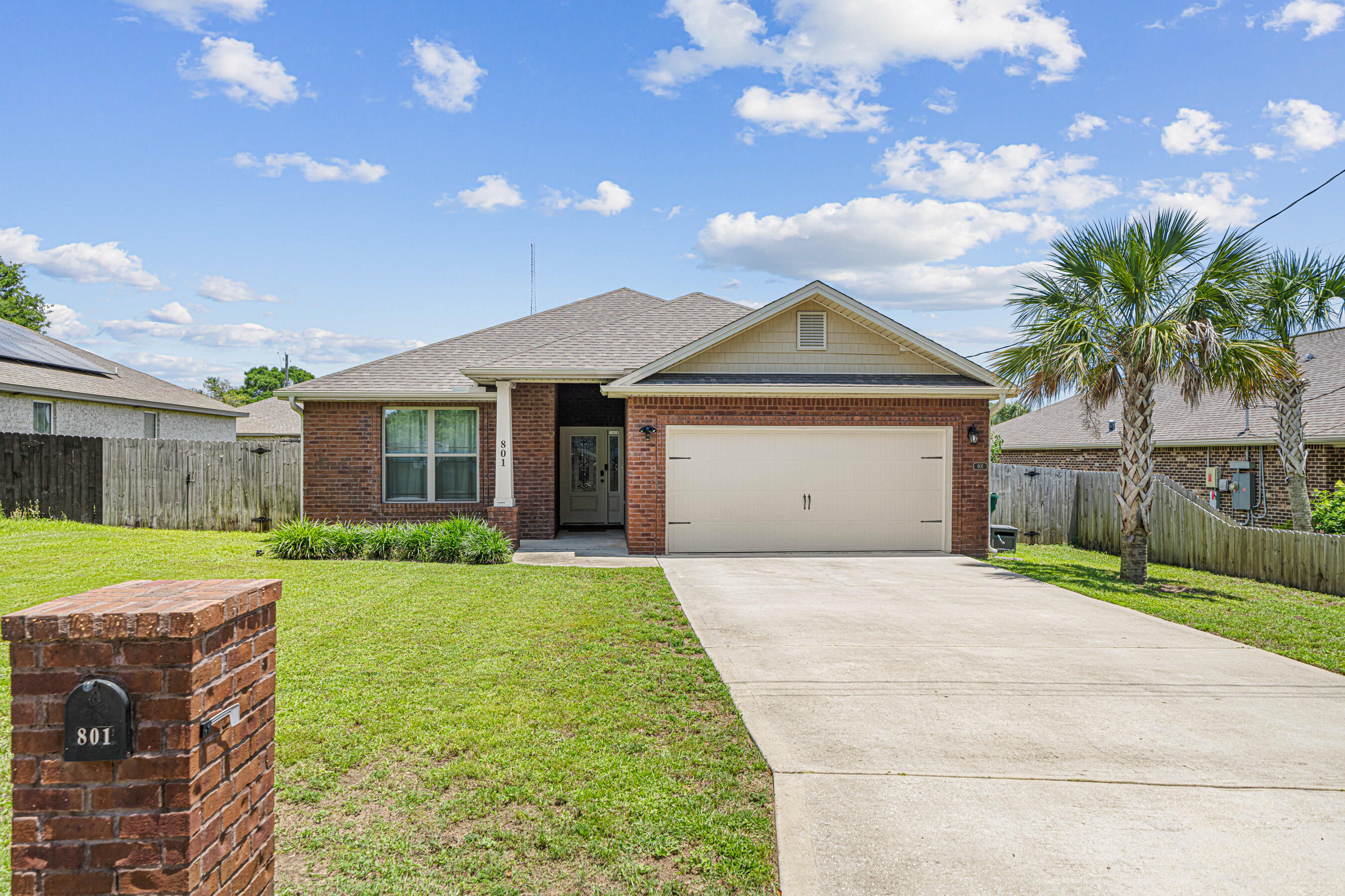 801 Playground Road Fort Walton Beach, FL 32547 - Photo 2 of 38 a front view of a house with a yard and garage