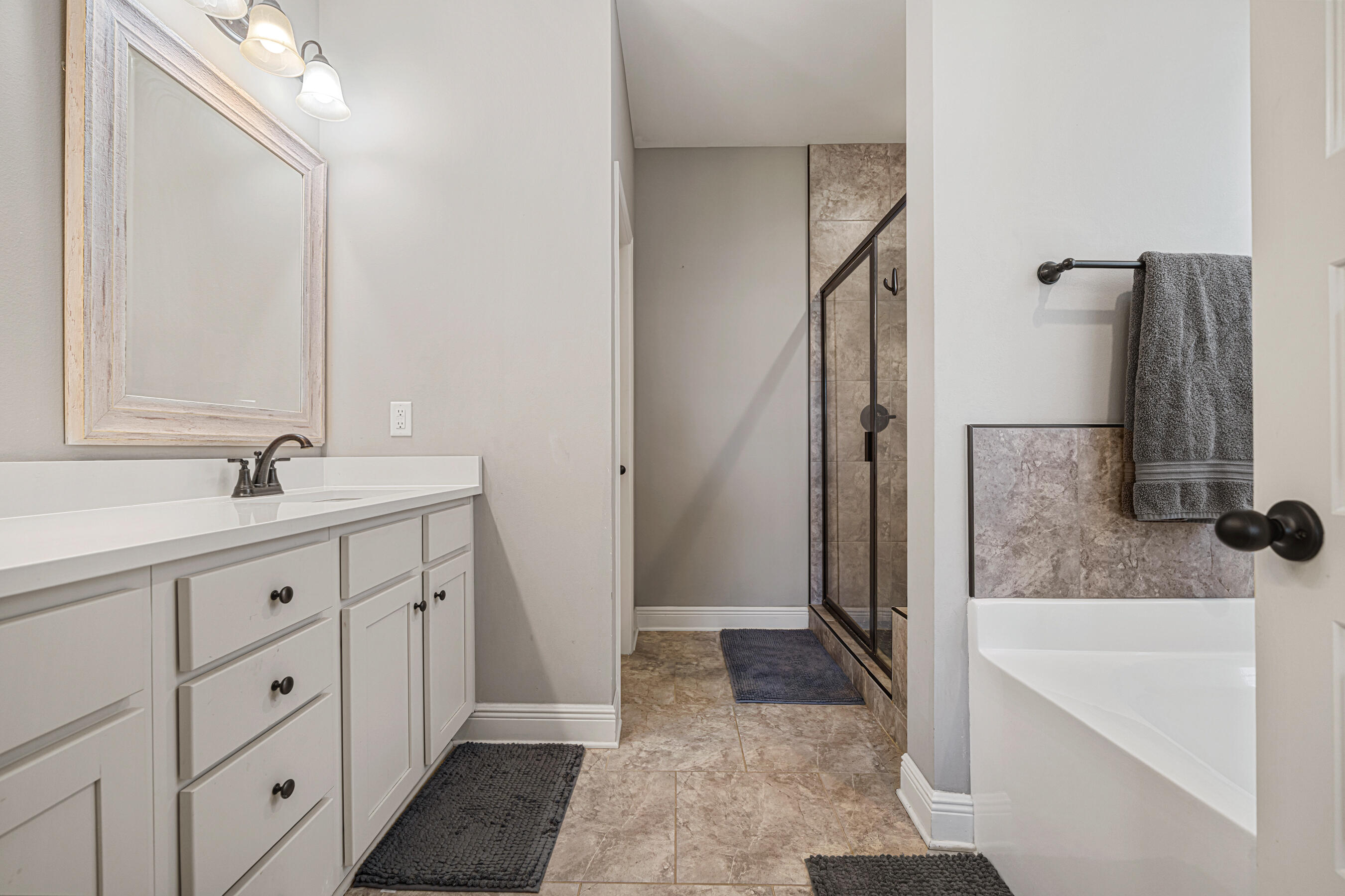 801 Playground Road Fort Walton Beach, FL 32547 - Photo 24 of 38 a bathroom with a double vanity sink a mirror and a bathtub