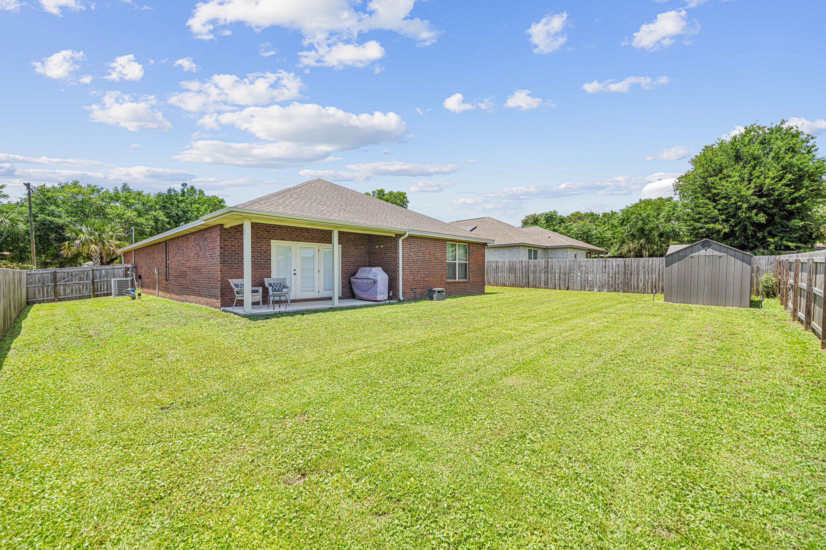 801 Playground Road Fort Walton Beach, FL 32547 - Photo 37 of 38 a view of a house with a backyard and a garden