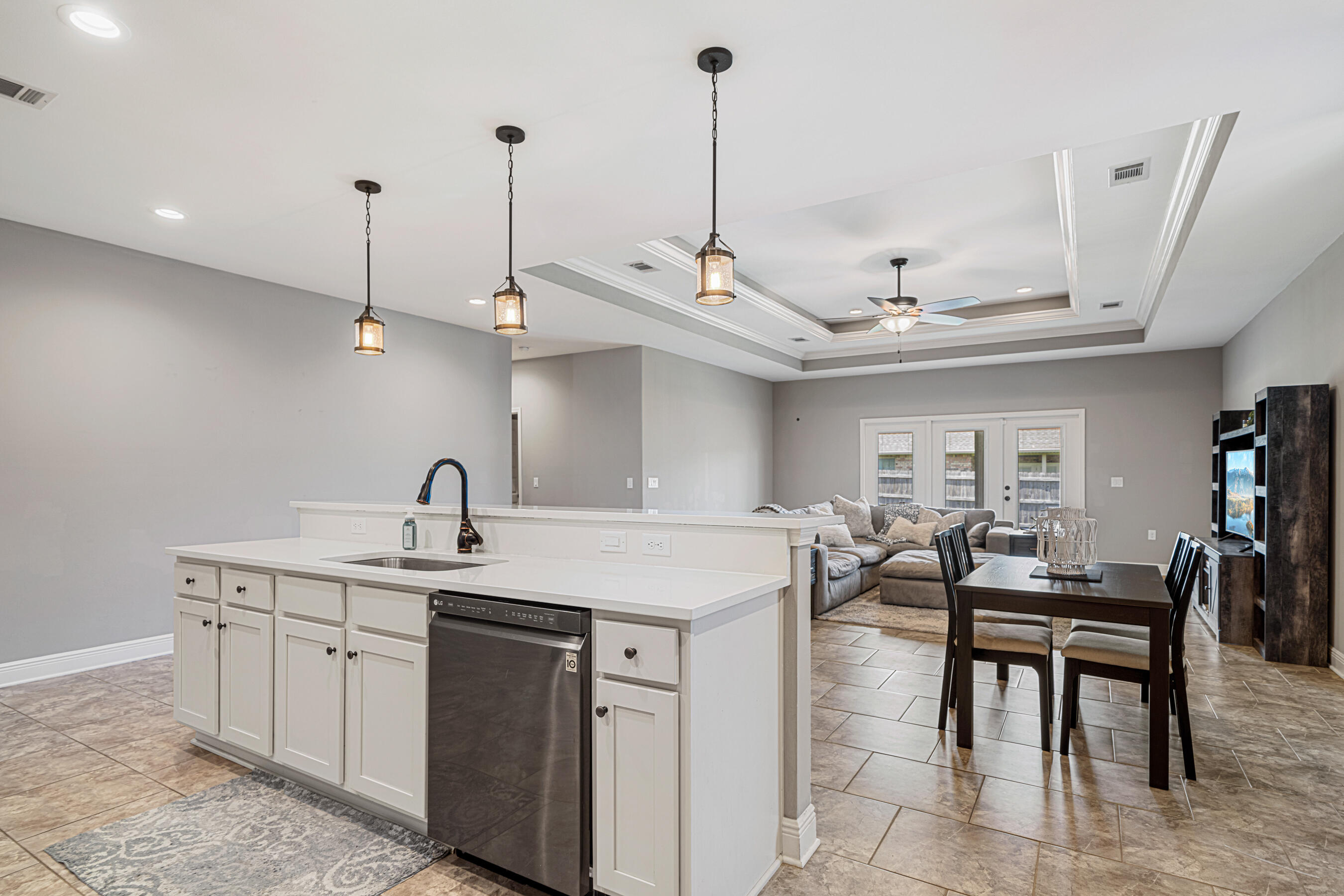 801 Playground Road Fort Walton Beach, FL 32547 - Photo 6 of 38 a kitchen with stainless steel appliances granite countertop a sink a oven a dining table and chairs with wooden floor