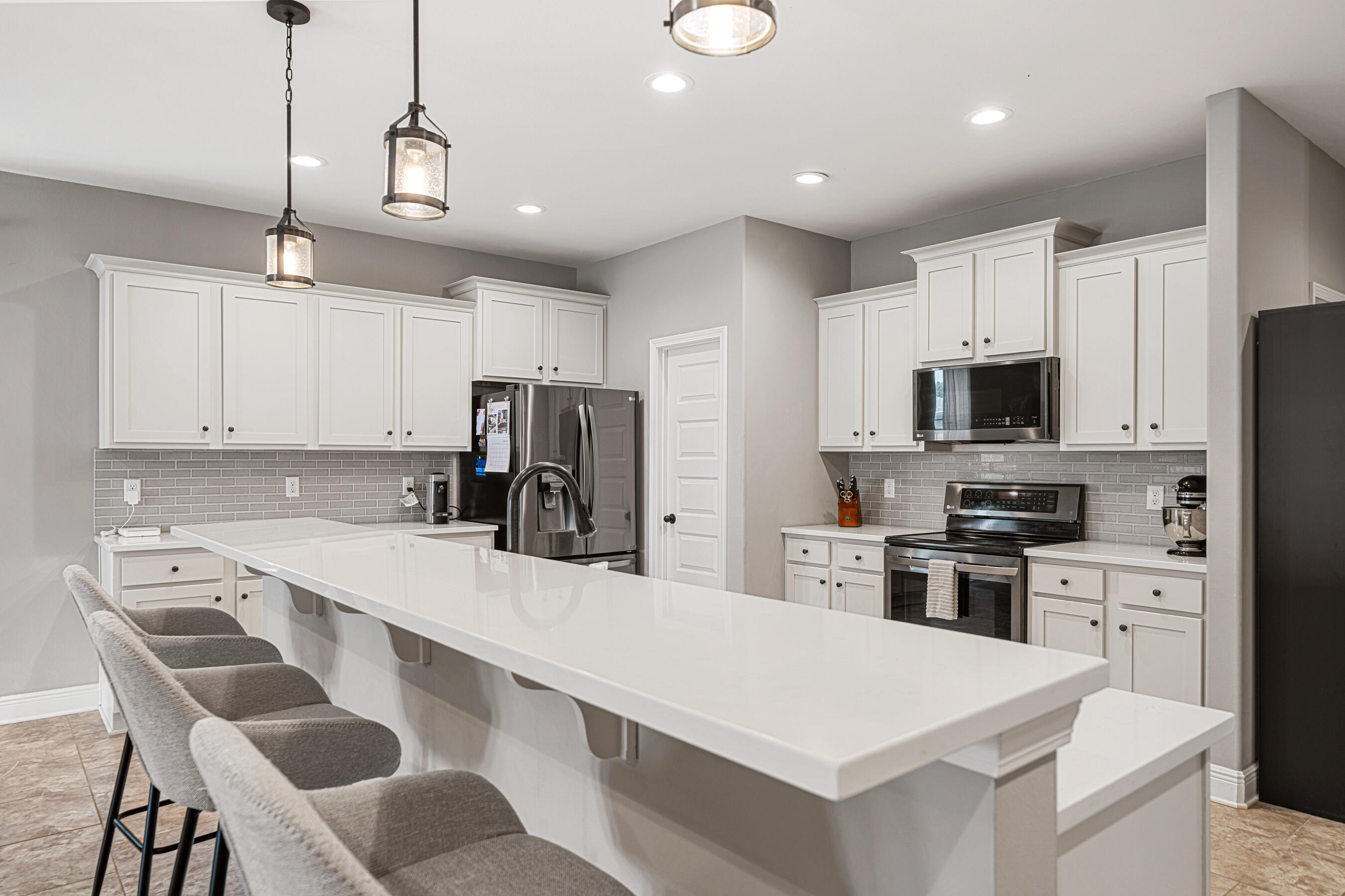 801 Playground Road Fort Walton Beach, FL 32547 - Photo 8 of 38 a kitchen with stainless steel appliances a stove refrigerator sink and microwave