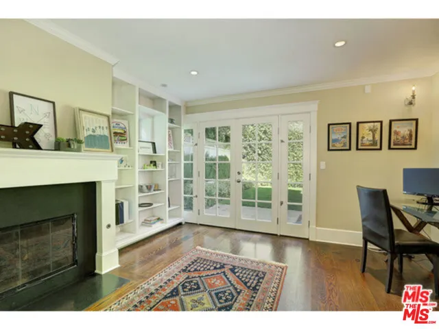 a living room with furniture wooden floor and a fireplace