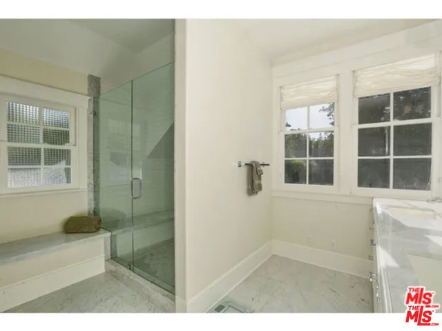 a bathroom with a shower and a bathtub