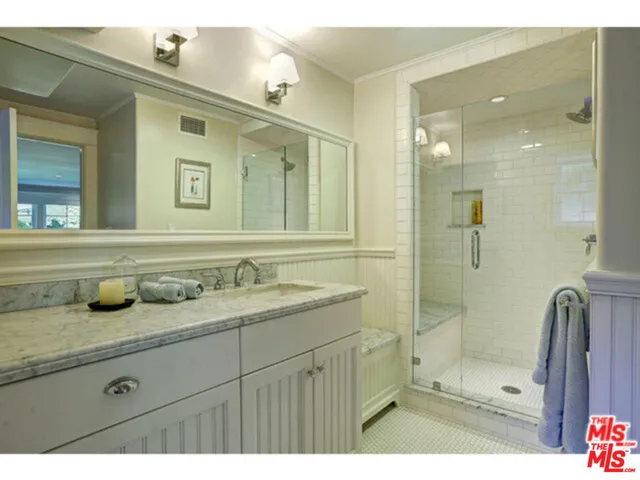 a bathroom with a granite countertop sink mirror and double