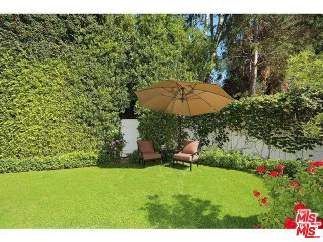 a view of backyard with outdoor seating and green space