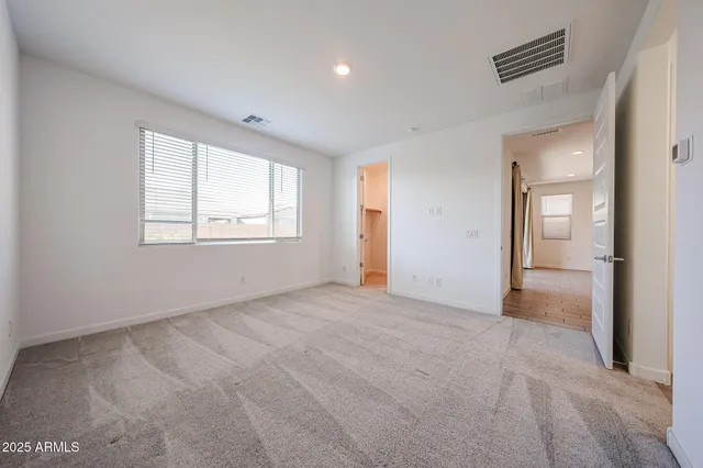 an empty room with windows and closet