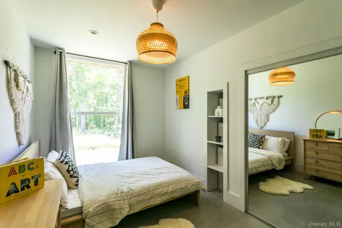 a living room with furniture a flat screen tv and a window