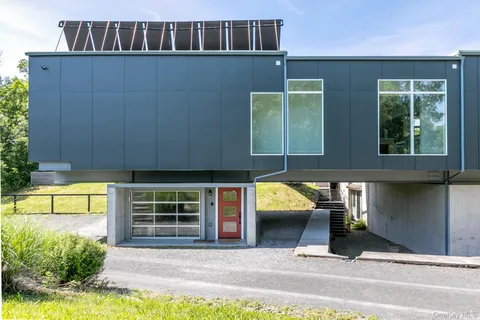 a view of a house with backyard and sitting area