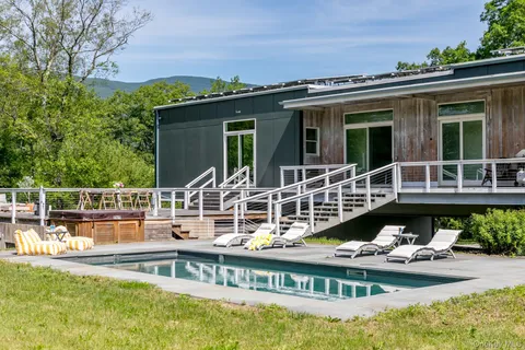 swimming pool view with a seating space