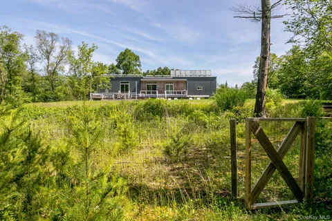 an aerial view of a house with swimming pool garden and patio