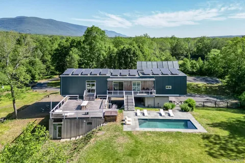 front view of a brick house with a yard