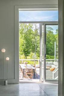 a kitchen with stainless steel appliances granite countertop a refrigerator a sink a stove and a refrigerator