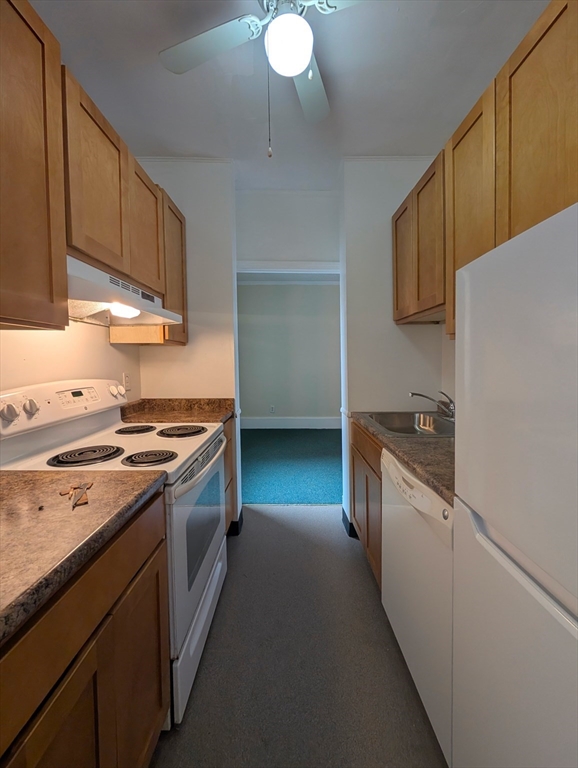 140 Chestnut Street, Unit 207 Springfield, MA 01103 - Photo 5 of 13 a kitchen with stainless steel appliances granite countertop a stove a sink and a refrigerator