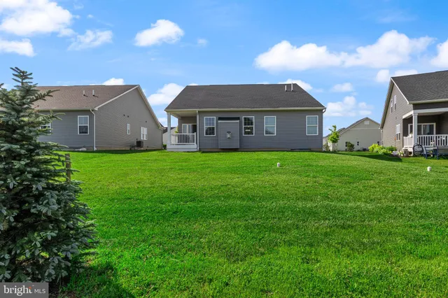 a view of hallway with livingroom and stairs