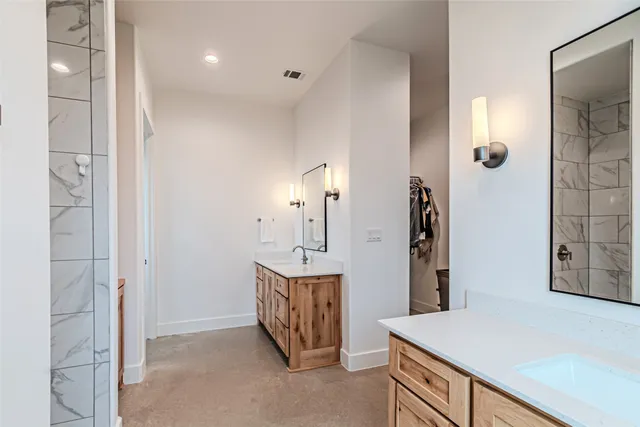 a bathroom with a granite countertop sink
