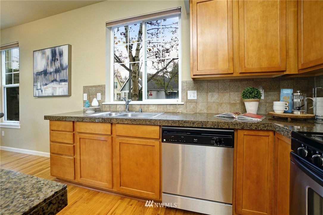 23927 33rd Drive Southeast, Unit 15 Bothell, WA 98021 - Photo 11 of 34 a kitchen with stainless steel appliances granite countertop a stove a sink and a microwave
