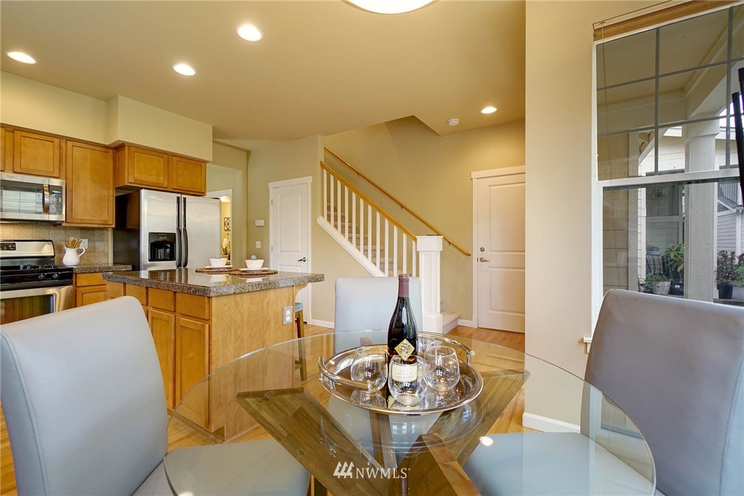 23927 33rd Drive Southeast, Unit 15 Bothell, WA 98021 - Photo 13 of 34 a dining room with furniture and a kitchen area