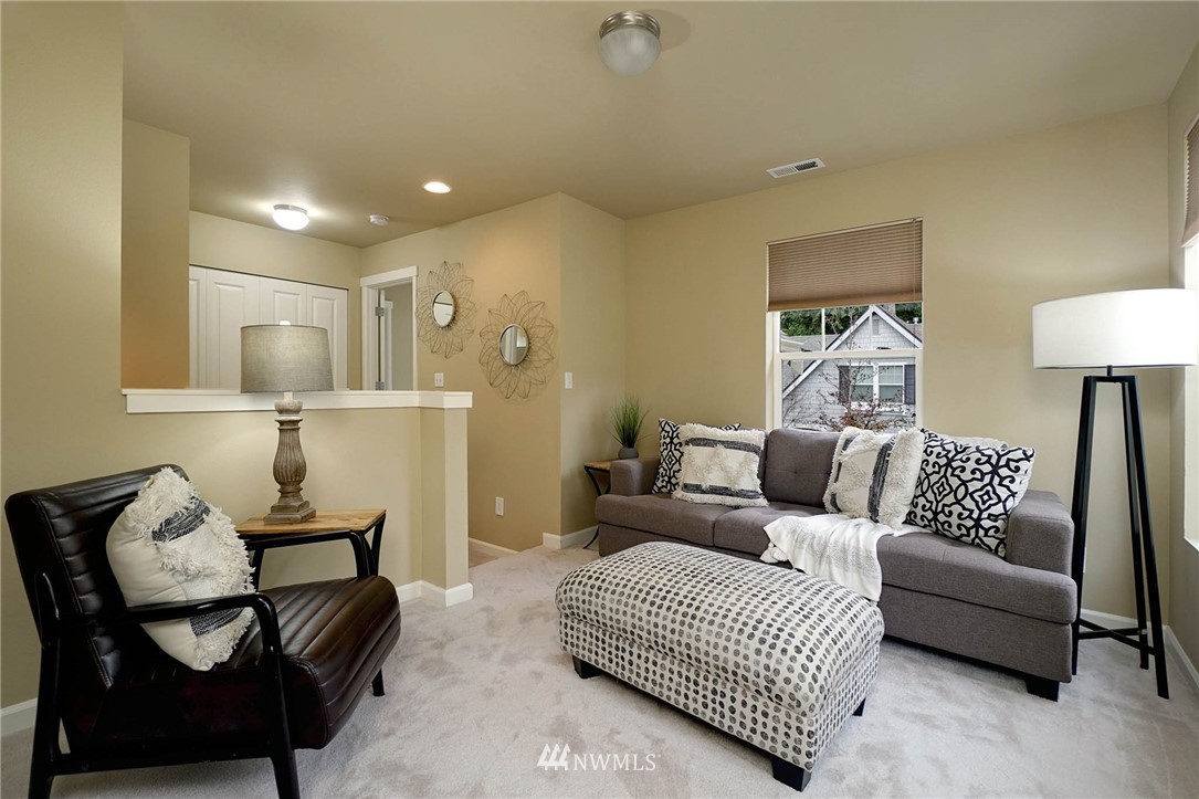 23927 33rd Drive Southeast, Unit 15 Bothell, WA 98021 - Photo 16 of 34 a living room with furniture and a lamp
