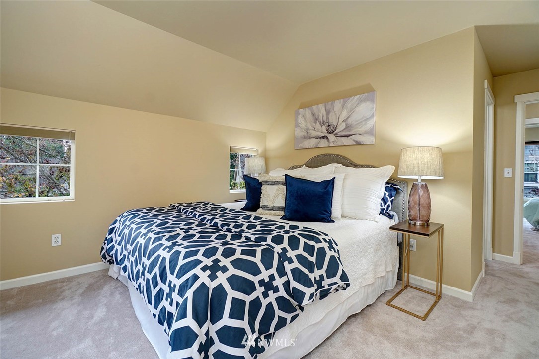 23927 33rd Drive Southeast, Unit 15 Bothell, WA 98021 - Photo 19 of 34 a bedroom with a bed and a lamp with window