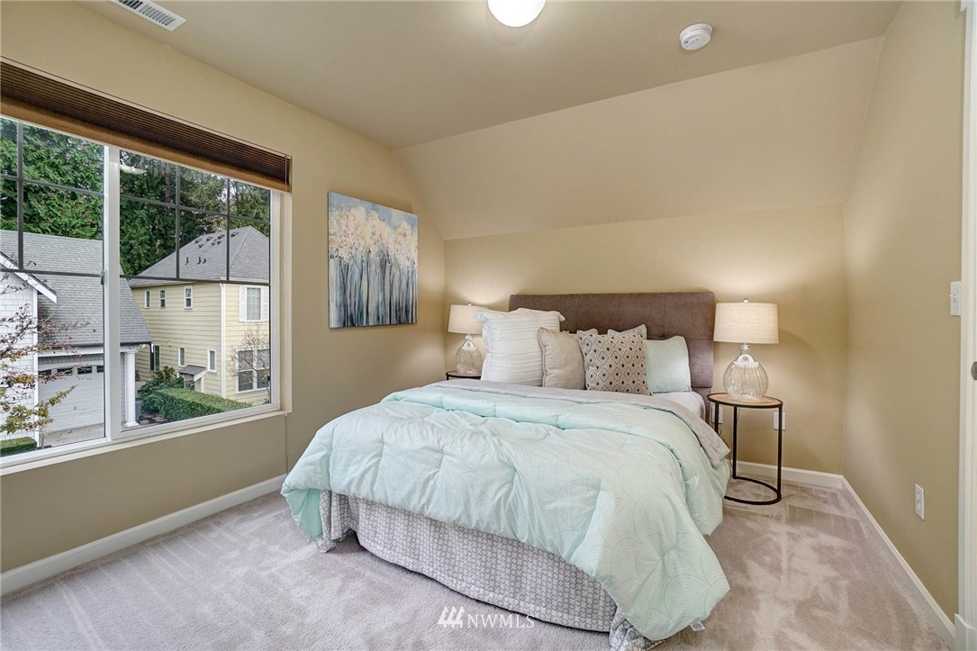 23927 33rd Drive Southeast, Unit 15 Bothell, WA 98021 - Photo 21 of 34 a bedroom with a bed and a large window