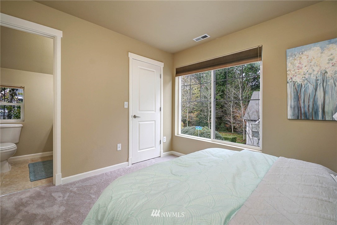 23927 33rd Drive Southeast, Unit 15 Bothell, WA 98021 - Photo 22 of 34 a bedroom with a bed and a large window