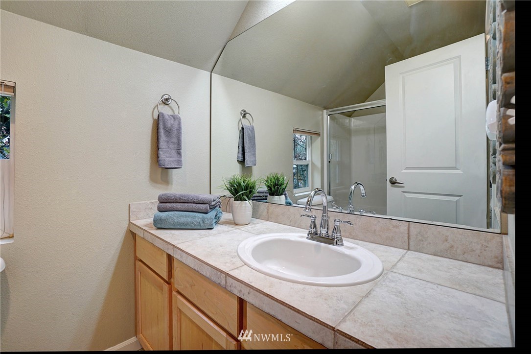 23927 33rd Drive Southeast, Unit 15 Bothell, WA 98021 - Photo 23 of 34 a bathroom with a sink and a mirror