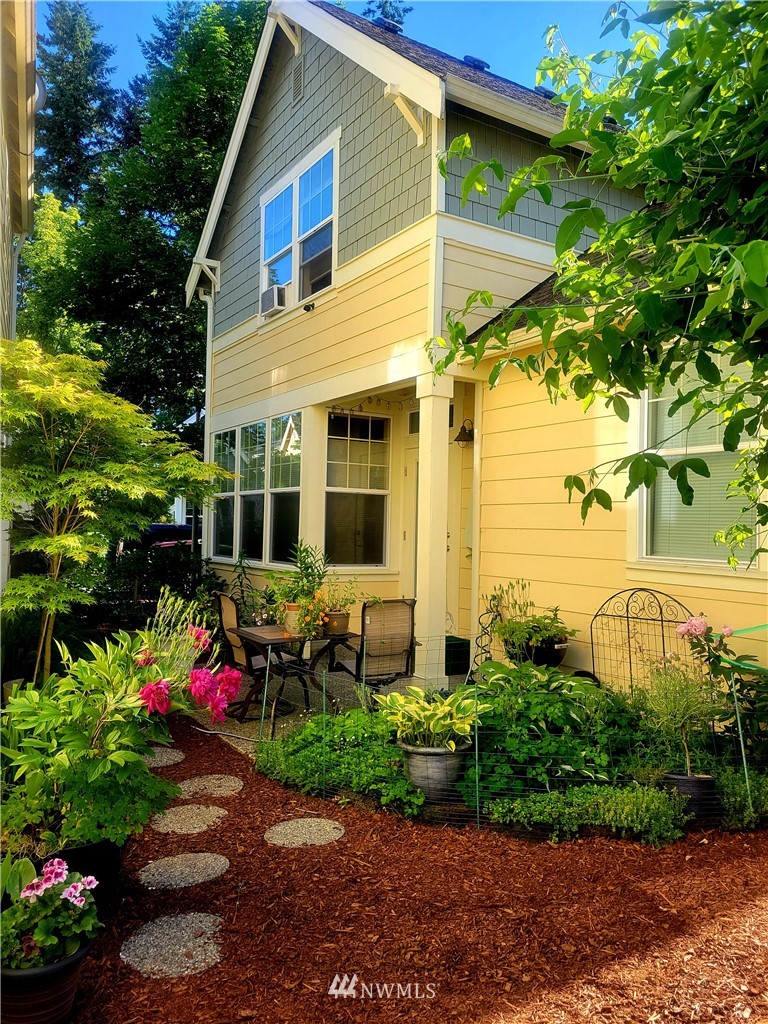 23927 33rd Drive Southeast, Unit 15 Bothell, WA 98021 - Photo 26 of 34 a front view of a house with a yard and potted plants