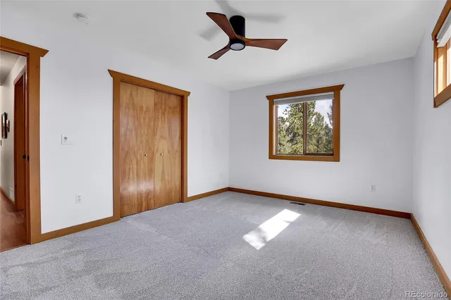 a view of empty room with ceiling fan