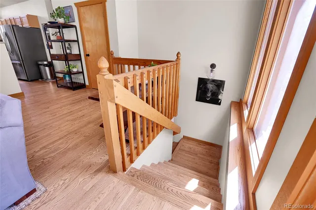 a view of entryway and hall with wooden floor