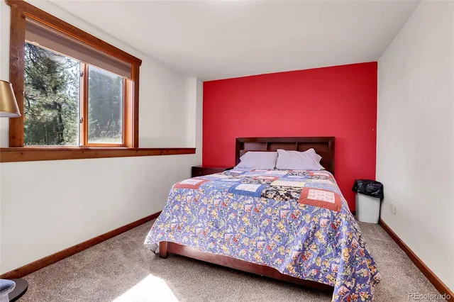 a bedroom with a bed and window