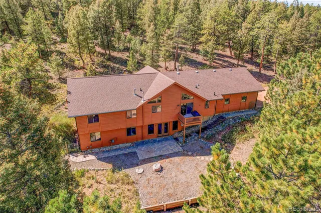 an aerial view of a house with a yard