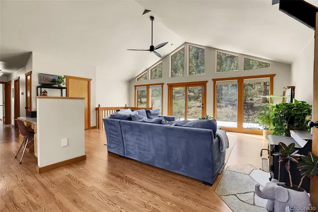 a living room with furniture and large windows