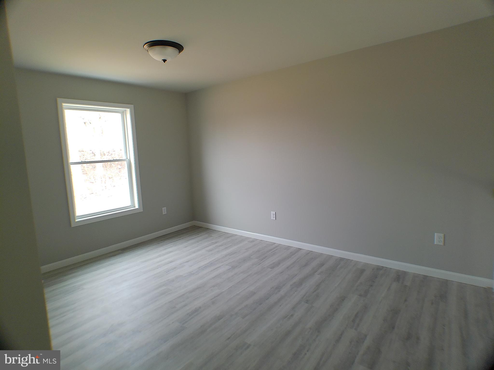 1735 Quarry Road Lebanon, PA 17046 - Photo 17 of 24 an empty room with wooden floor and windows