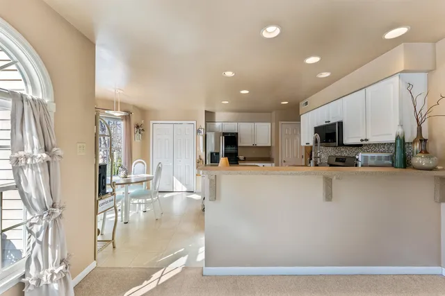a large kitchen with a table and chairs