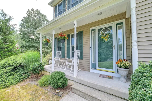 a view of a hallway with dining room and stairs