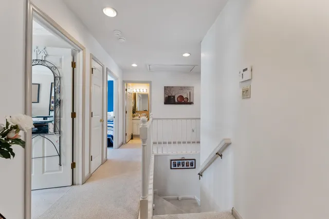 a spacious bedroom with a bed and dresser