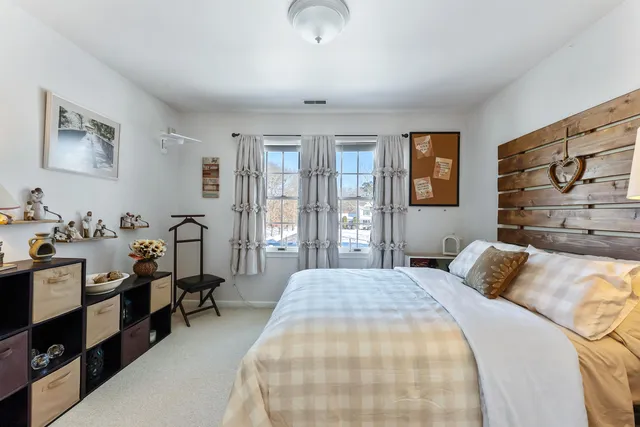 a view of a white house with swimming pool in front of it