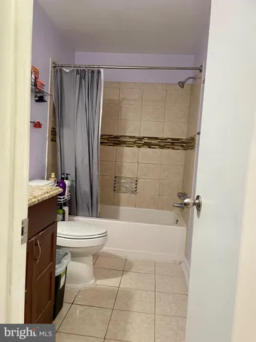 a bathroom with a granite countertop sink a toilet and a mirror
