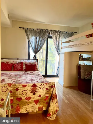 a bedroom with a bed and a mirror