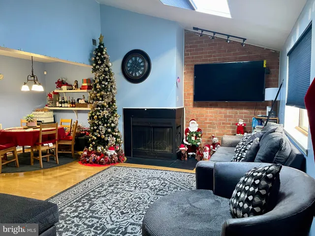 a living room with furniture a rug and a fireplace